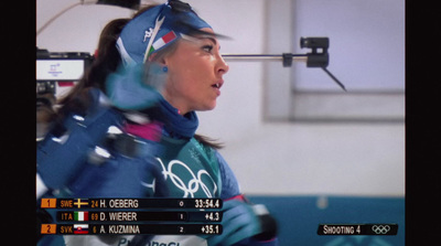 a woman in a blue ski suit holding a ski pole