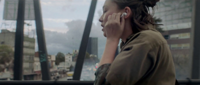 a woman talking on a cell phone in a city