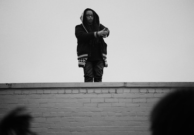 a man standing on top of a brick wall