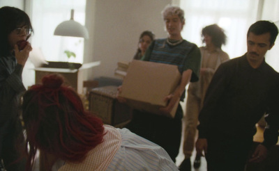 a group of people standing around a living room