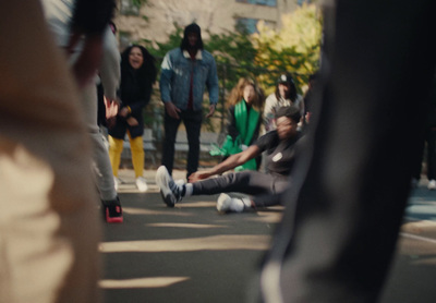 a group of people standing and sitting on the side of a road