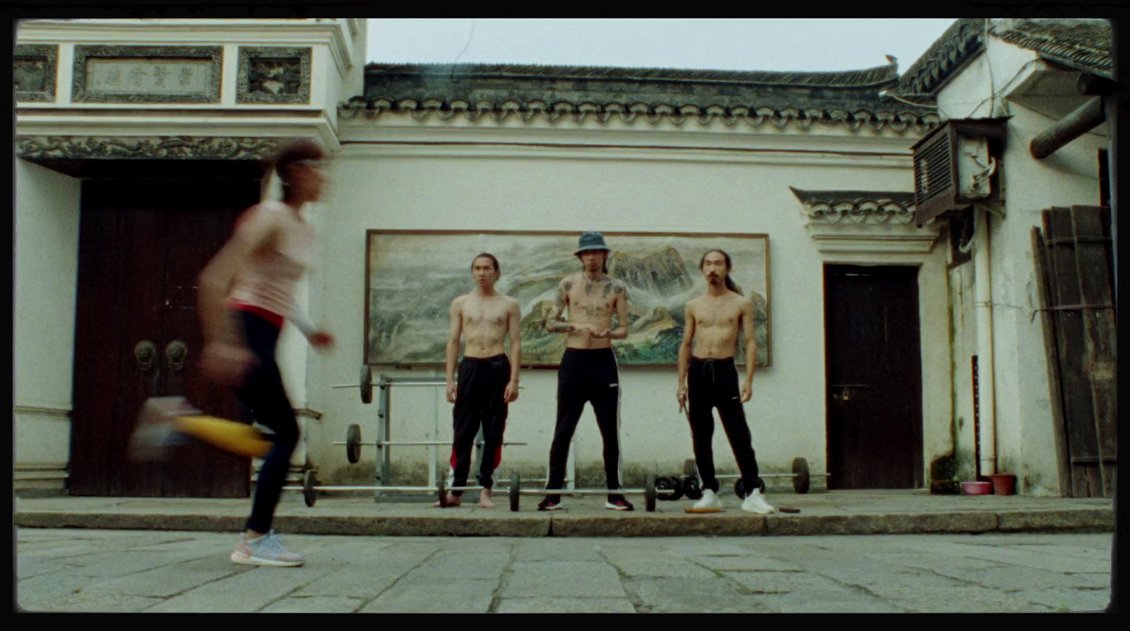 a group of men standing next to each other in front of a building