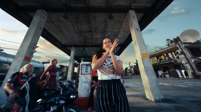 a woman standing in front of a gas station