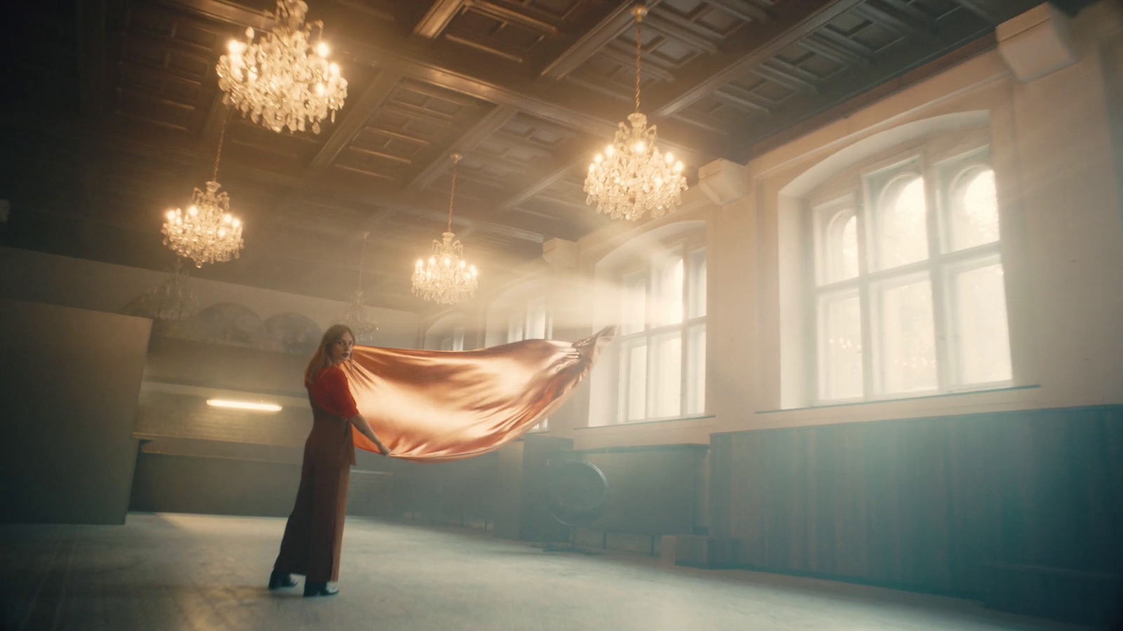 a woman is standing in a large room