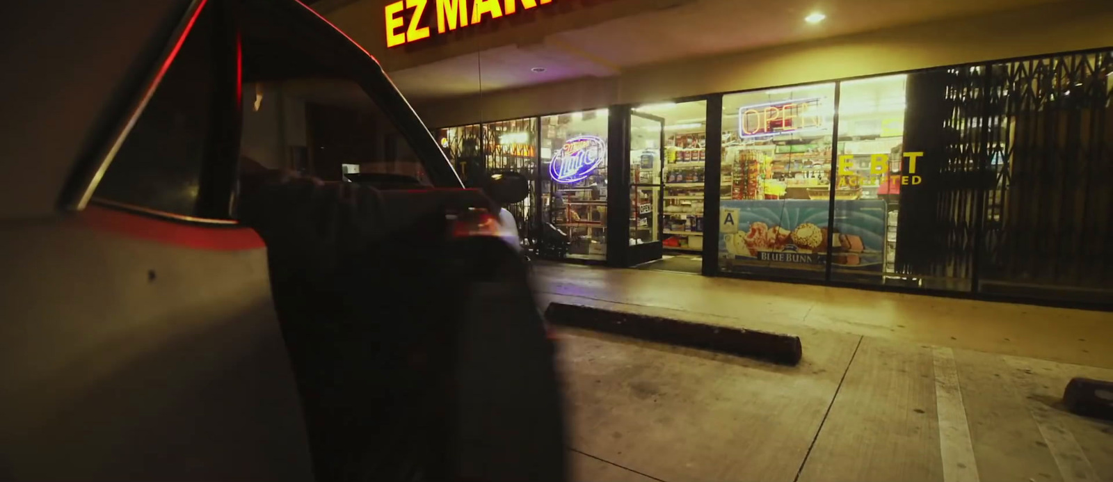 a car parked in front of a store at night