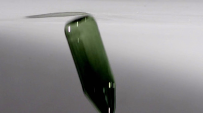 a close up of a green object in water