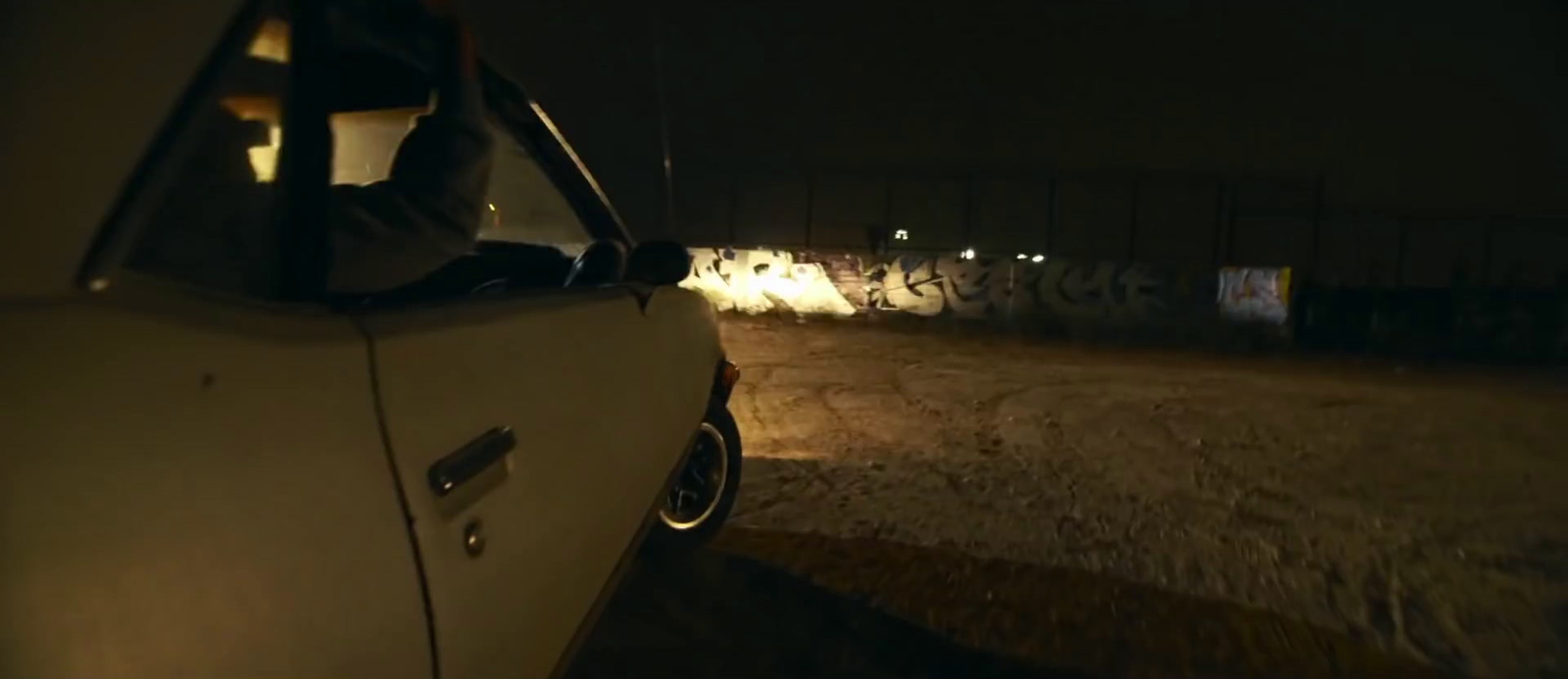 a car parked on the side of the road at night