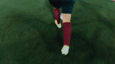 a soccer player kicking a soccer ball on a field