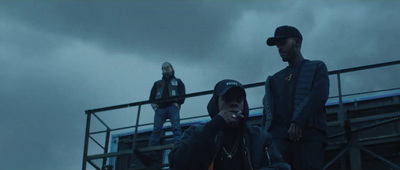 a group of people standing on top of a bridge