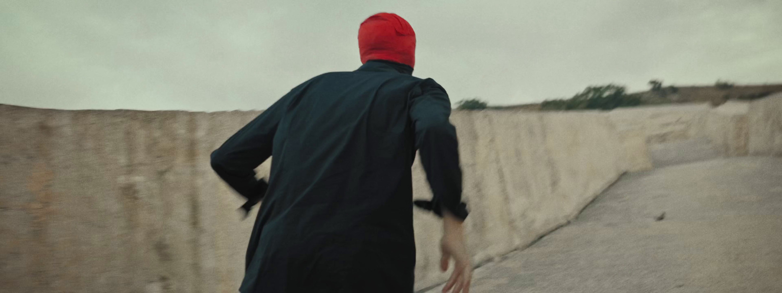 a man in a red hat is walking down the street