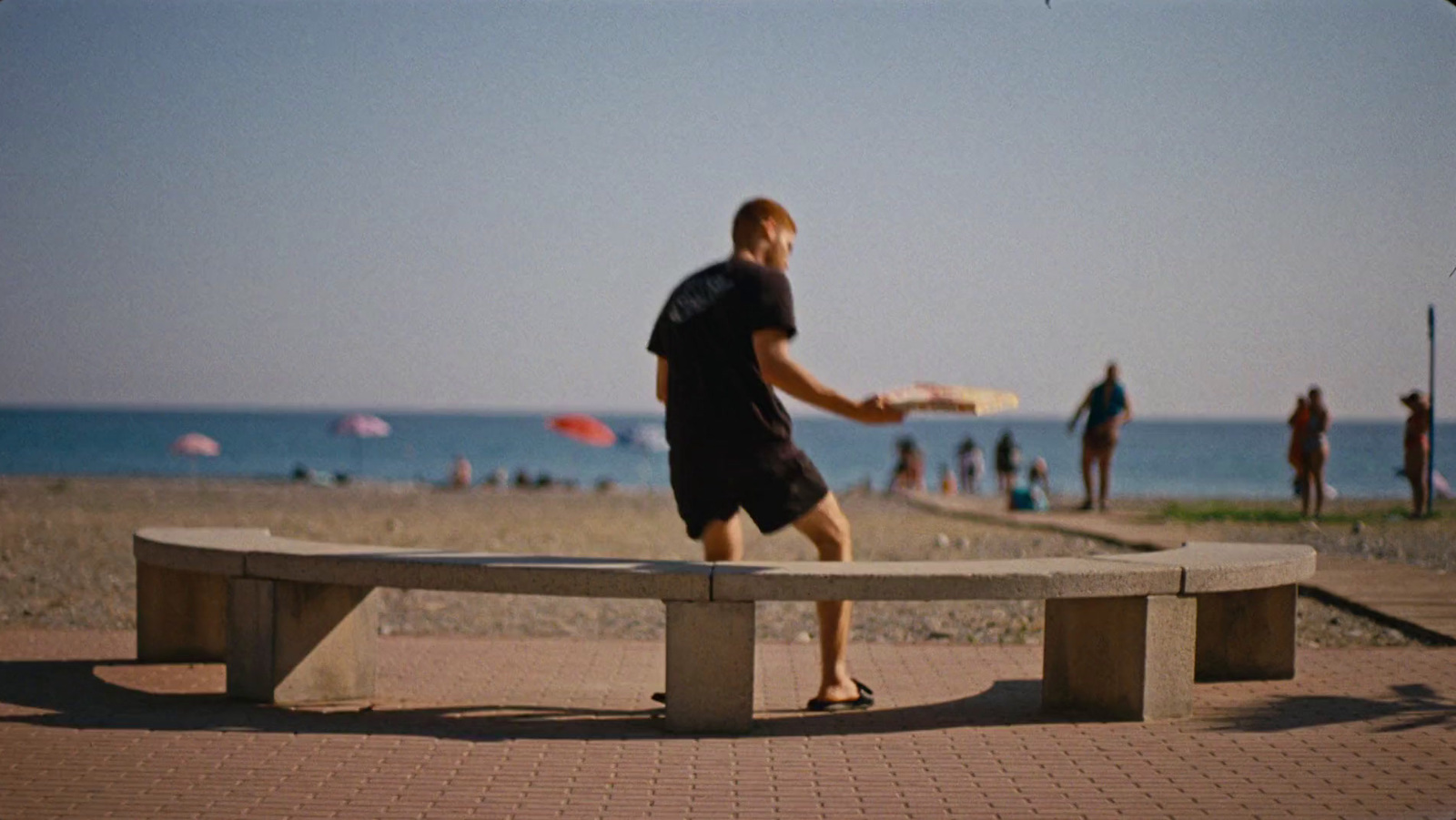 a man is throwing a frisbee on a bench