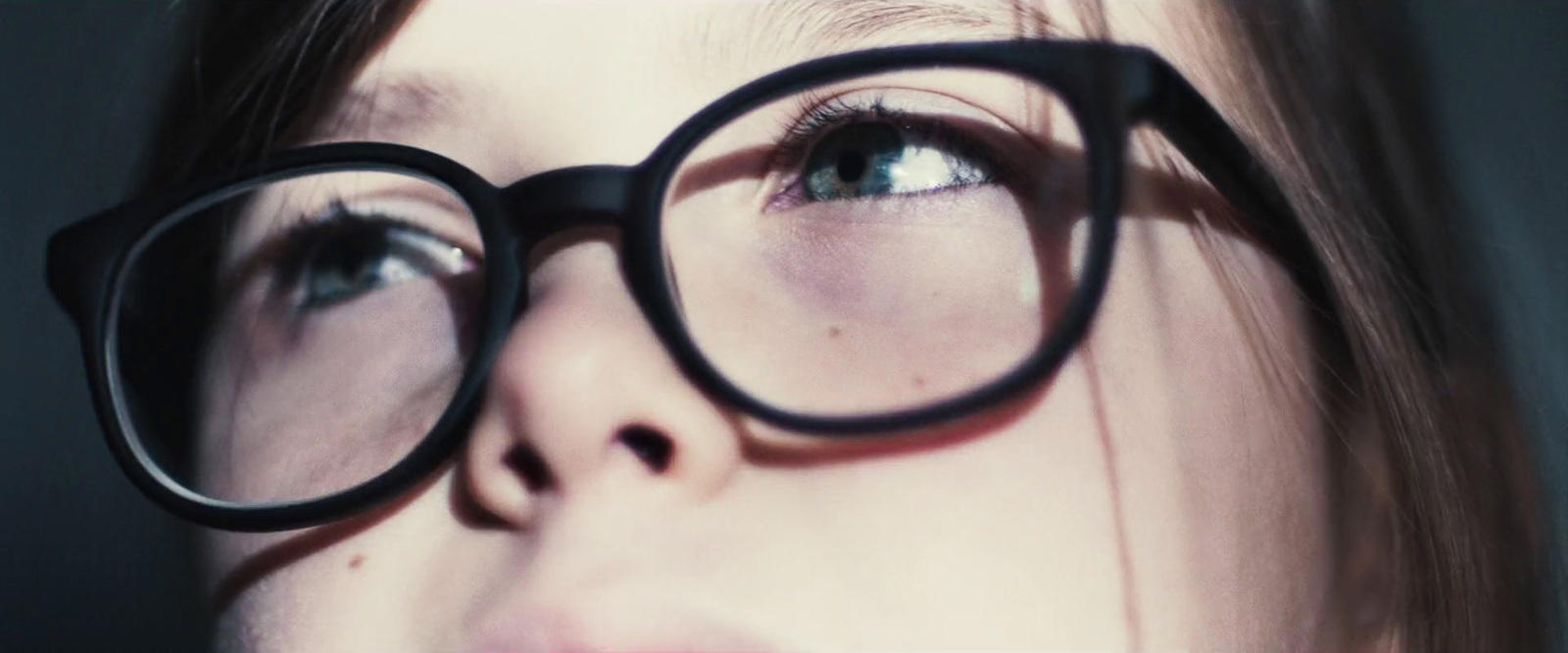 a close up of a person wearing glasses