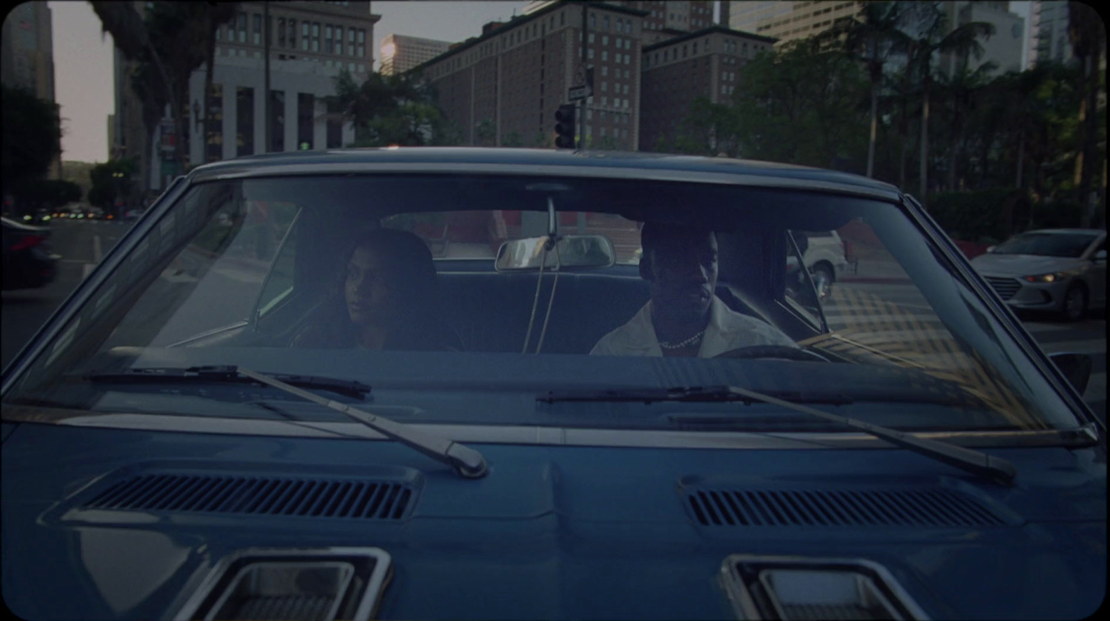 a man and a woman sitting in a car