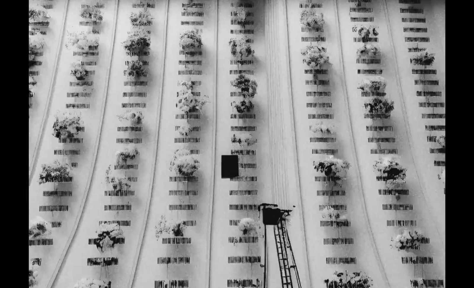 a black and white photo of snow on a building