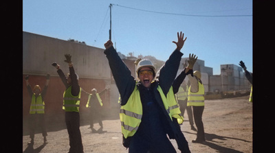 a group of people in yellow vests and safety vests