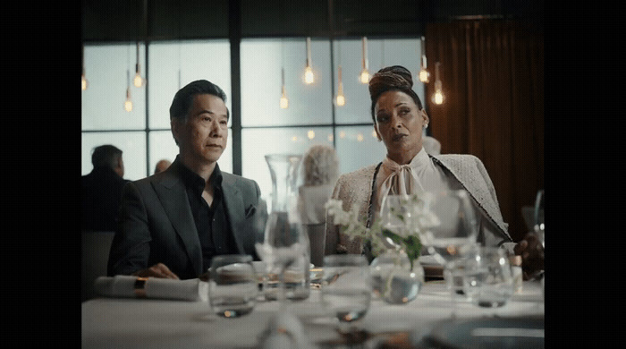 a man and a woman sitting at a dinner table