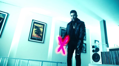 a man standing in a room holding a neon pink object