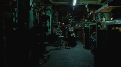 a dark room with lots of clutter on the floor