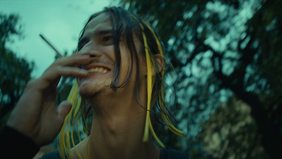 a man with dreadlocks smoking a cigarette