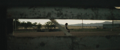 a man standing on a baseball field holding a bat