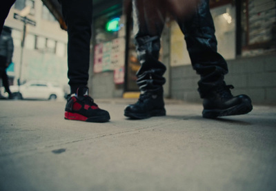 a couple of people standing next to each other on a sidewalk