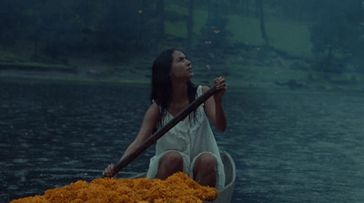 a woman sitting on a boat in the water