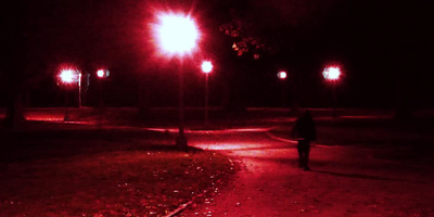 a person walking down a street at night