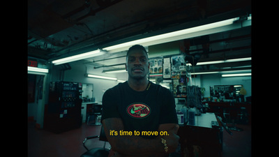 a man standing in a room with his arms crossed