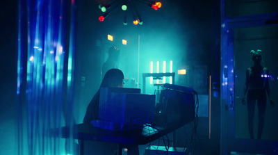 a woman sitting at a desk in front of a laptop computer