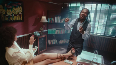 a man and a woman sitting at a desk in a room