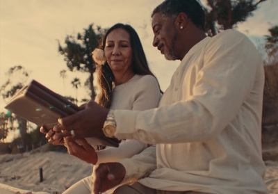 a man and a woman sitting on a beach