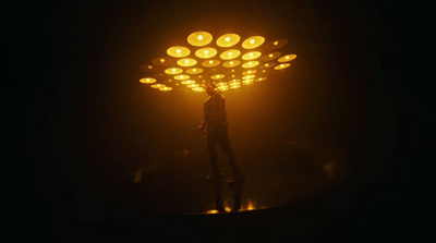 a person standing in the dark under a light fixture