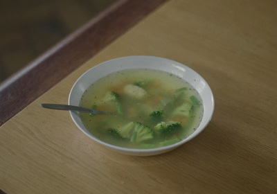 a bowl of broccoli soup with a spoon in it