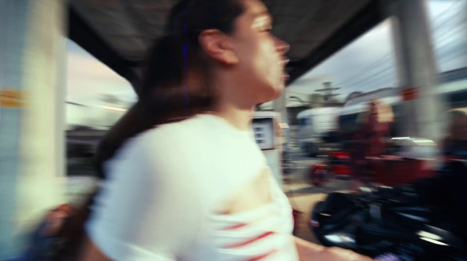 a woman riding a motorcycle down a street