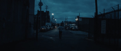 a person walking down a street at night