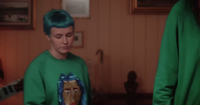 a man with green hair and a green shirt