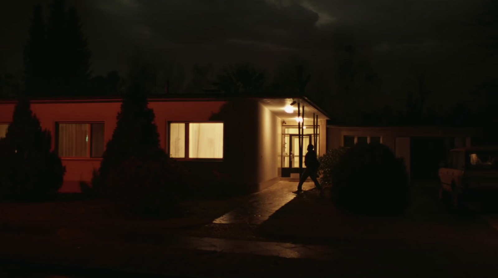 a house is lit up at night in the dark