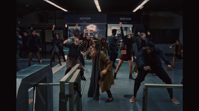 a group of people standing around a train station