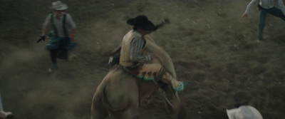 a man riding on the back of a brown horse