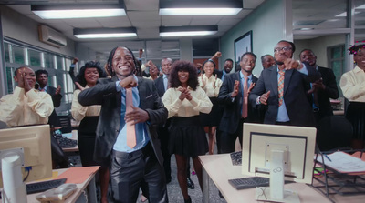 a man in a suit and tie standing in front of a group of people