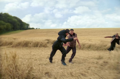 a group of men playing a game of frisbee in a field