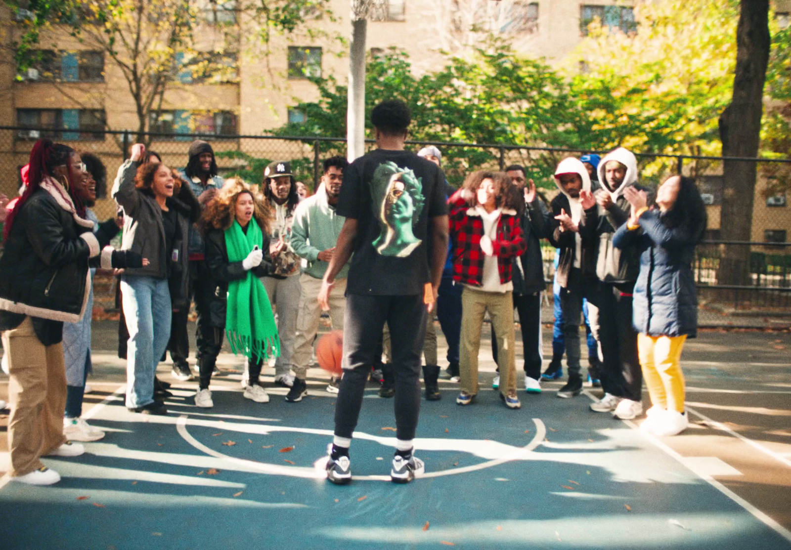 a group of people standing around a man on a skateboard