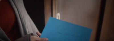 a person holding a blue folder in their hand