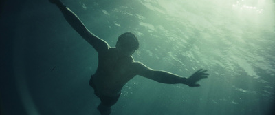 a man swimming in the water with his arms outstretched