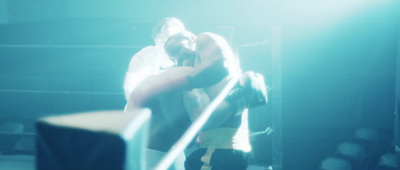 a man standing next to a woman in a boxing ring