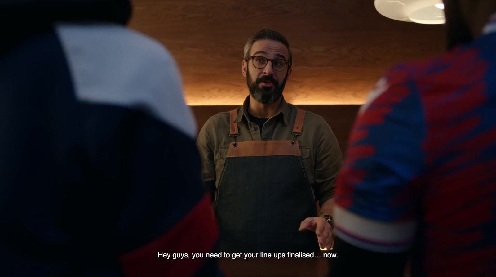 a man standing in front of a mirror wearing an apron