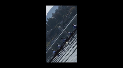 a group of people riding skis down a snow covered slope