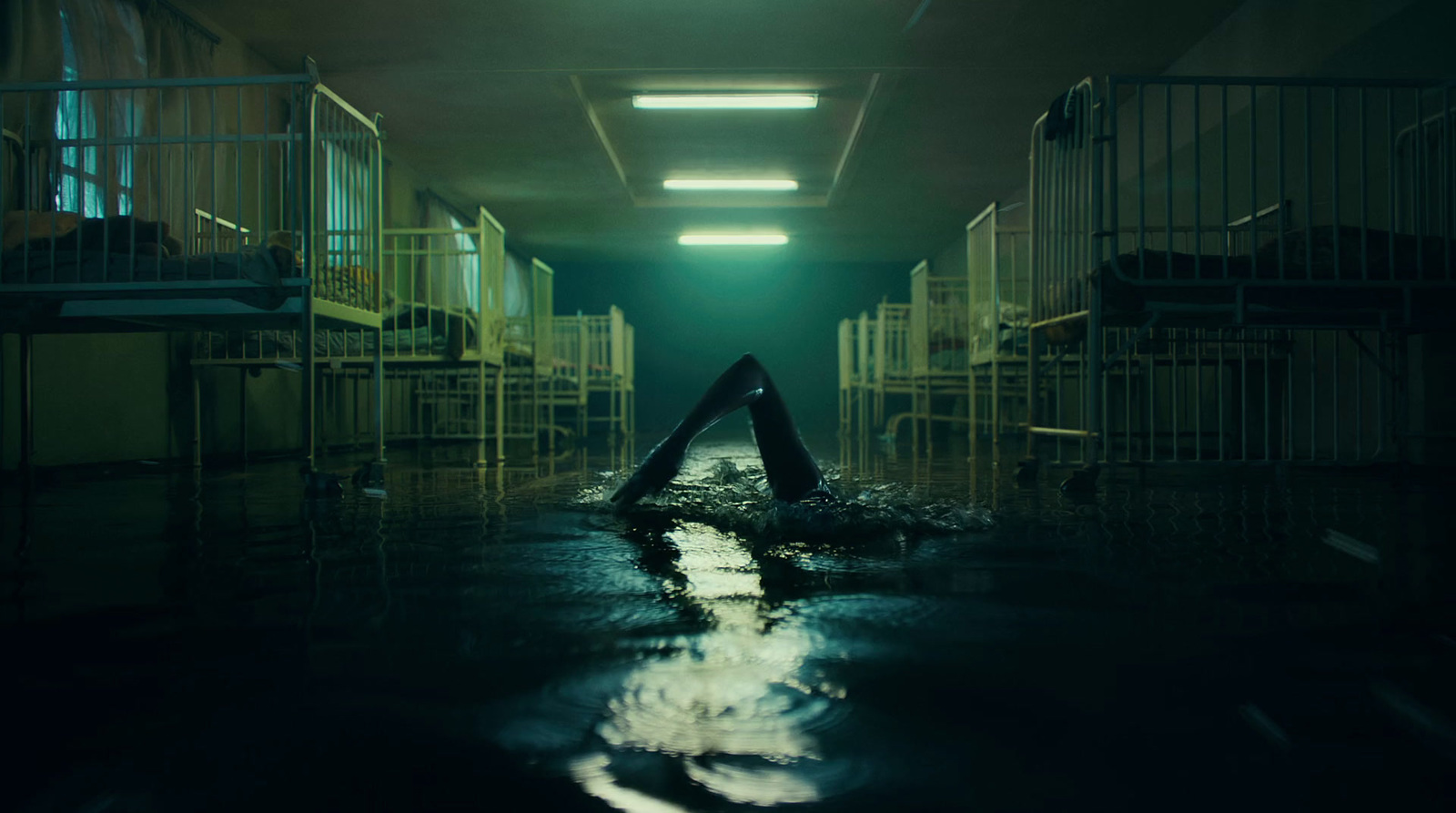 a dark hallway with a pool of water on the floor