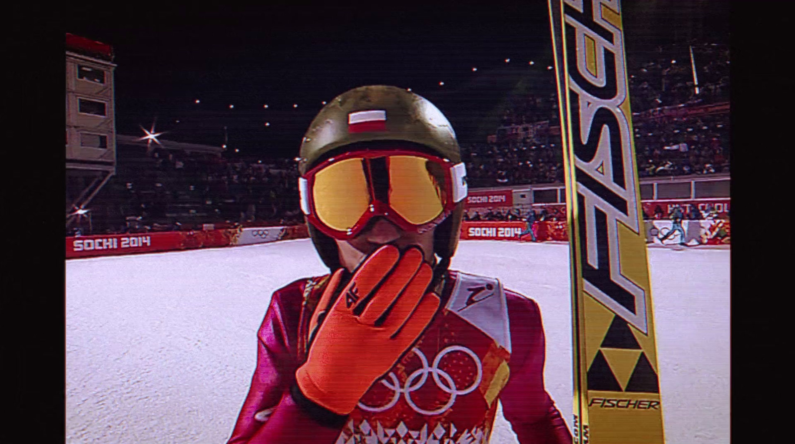 a person in a red ski suit holding a pair of skis