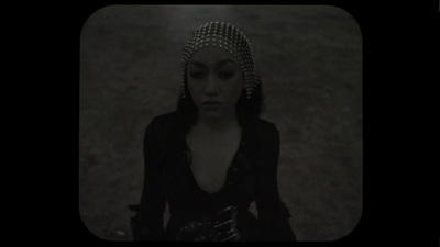 a woman in a black dress and a headpiece